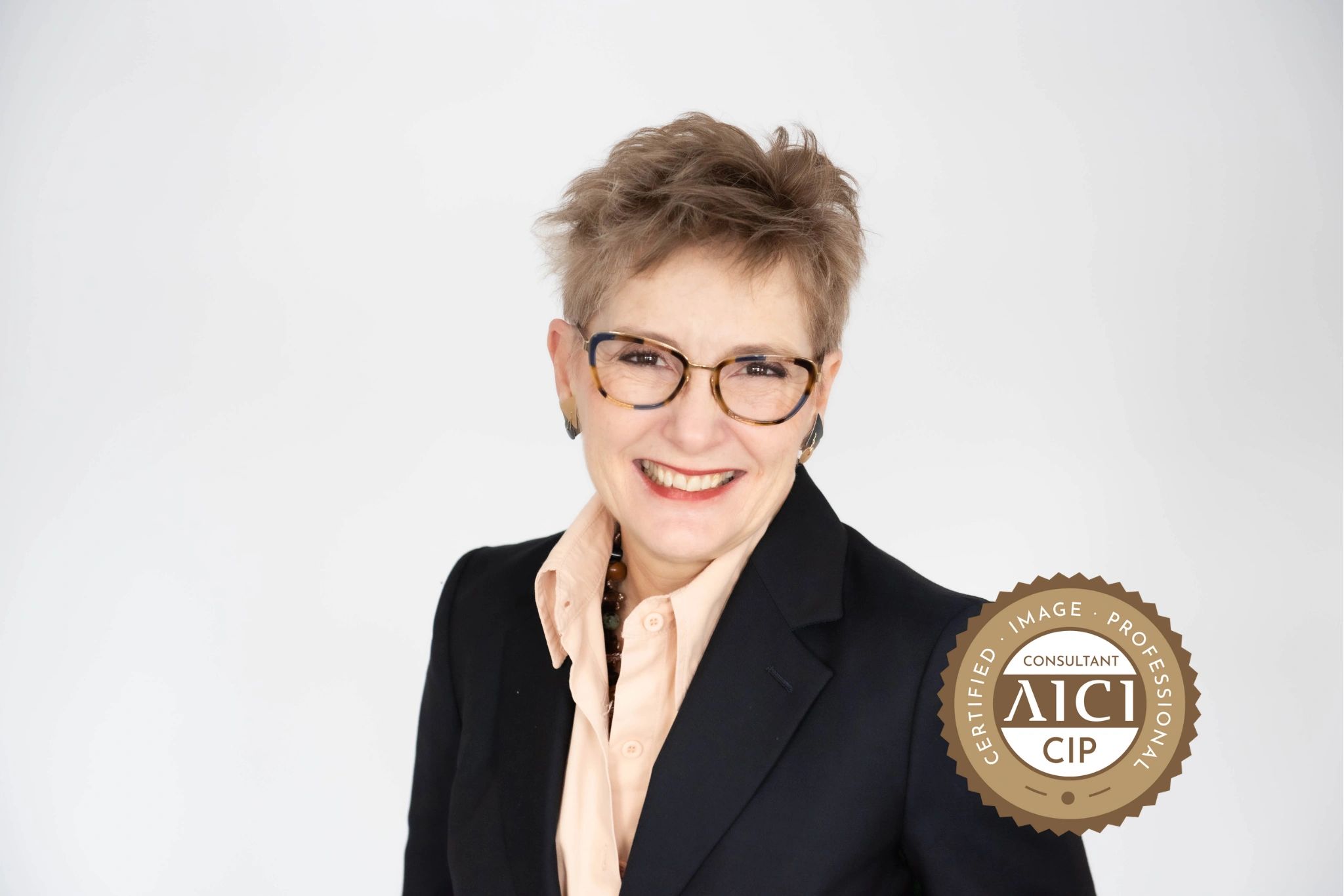 Professional woman smiling confidently with a certification badge.